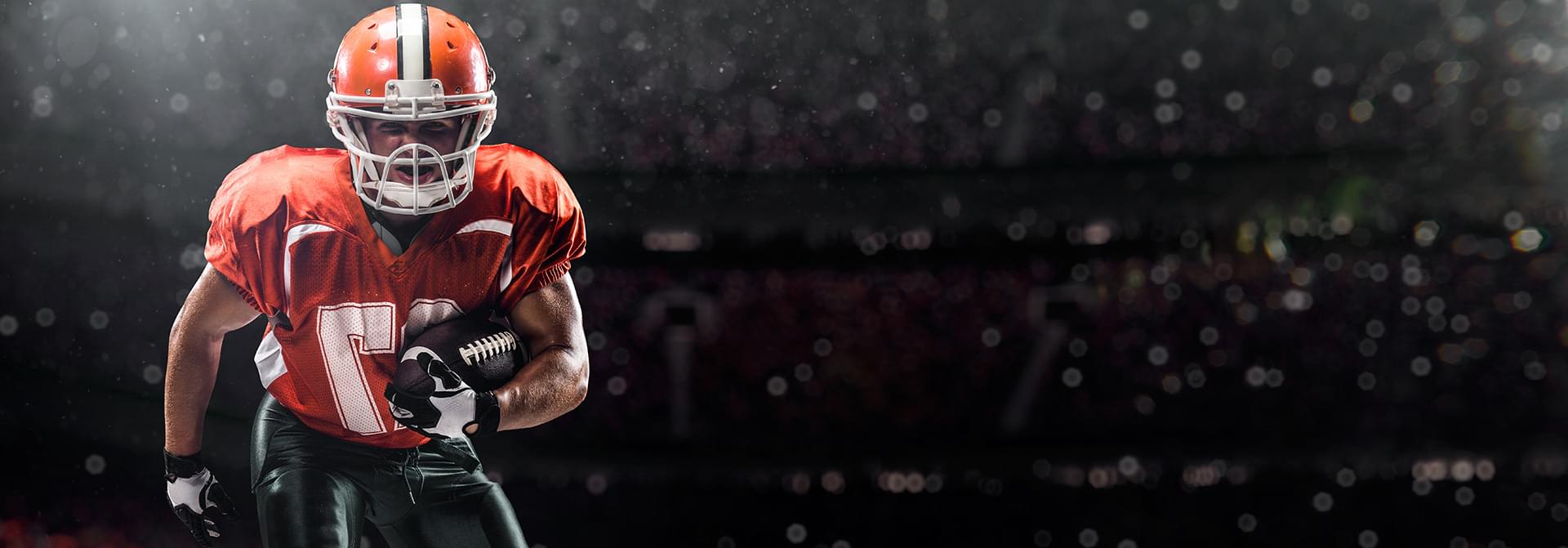 American football player charging with ball