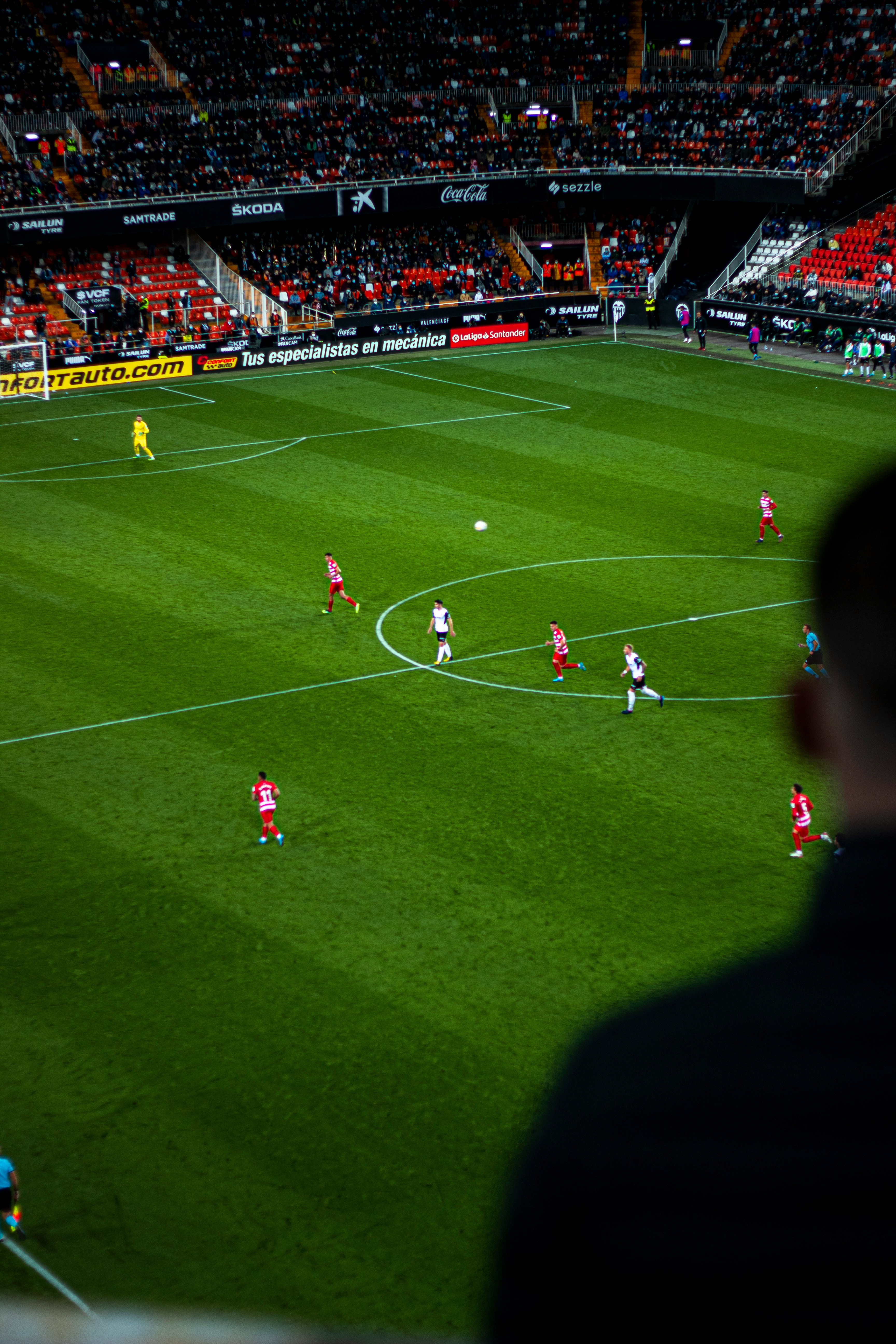 Football match in a packed stadium at night