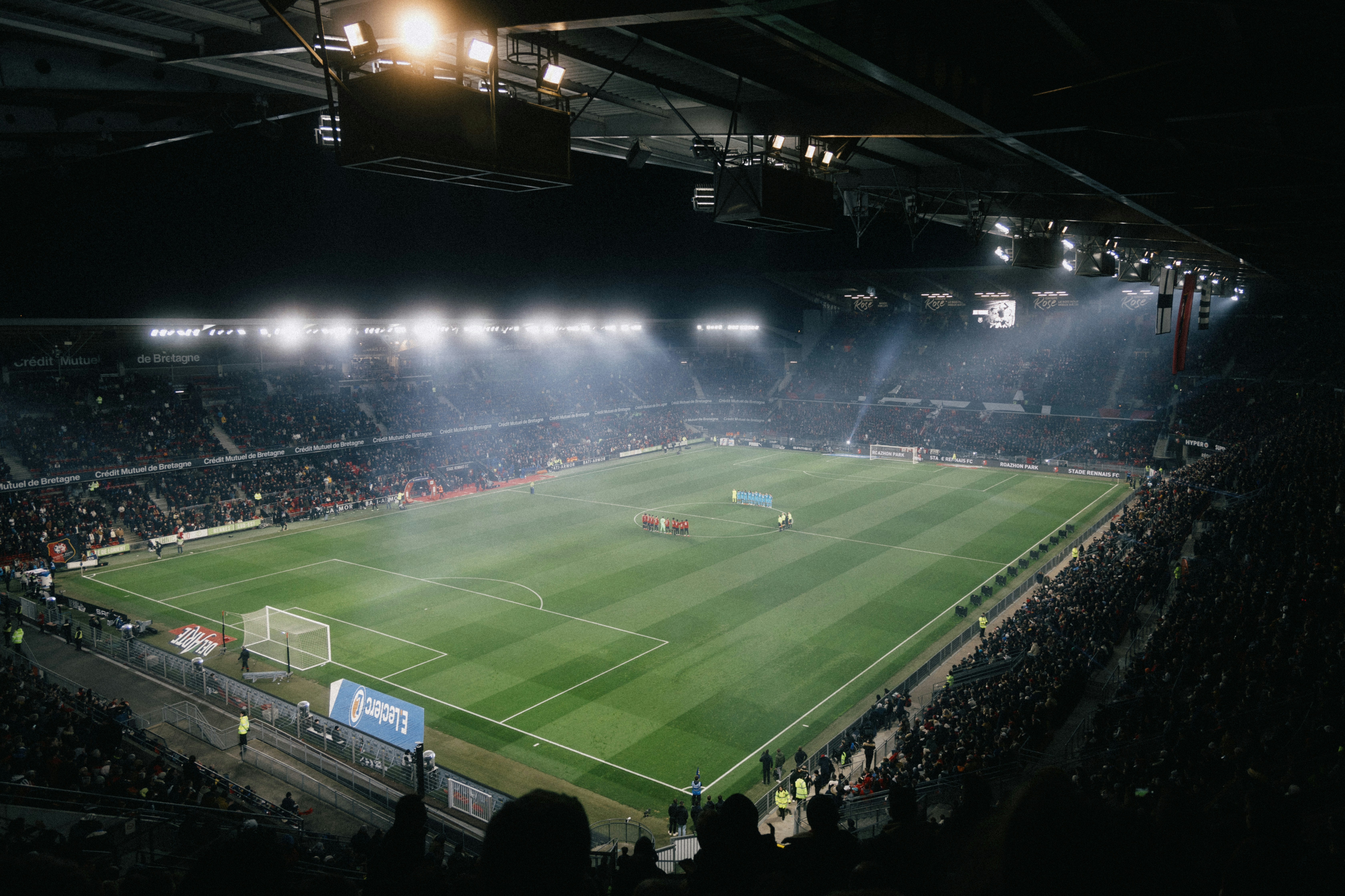 Floodlit football stadium at night